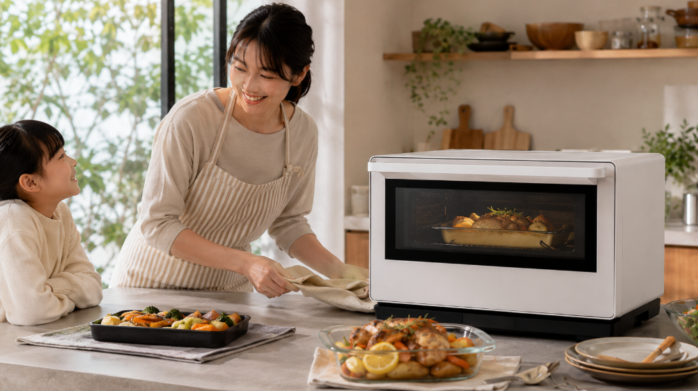 家族の料理に大型オーブンレンジを活用する様子で、ES-GX26の多機能な調理用途をイメージ